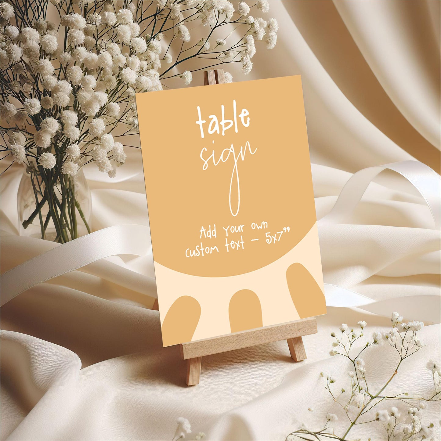 a table sign with a vase of white flowers in the background.