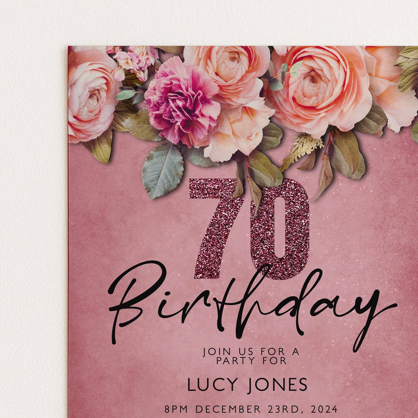 A pink birthday party invitation with a floral design and the number 70.