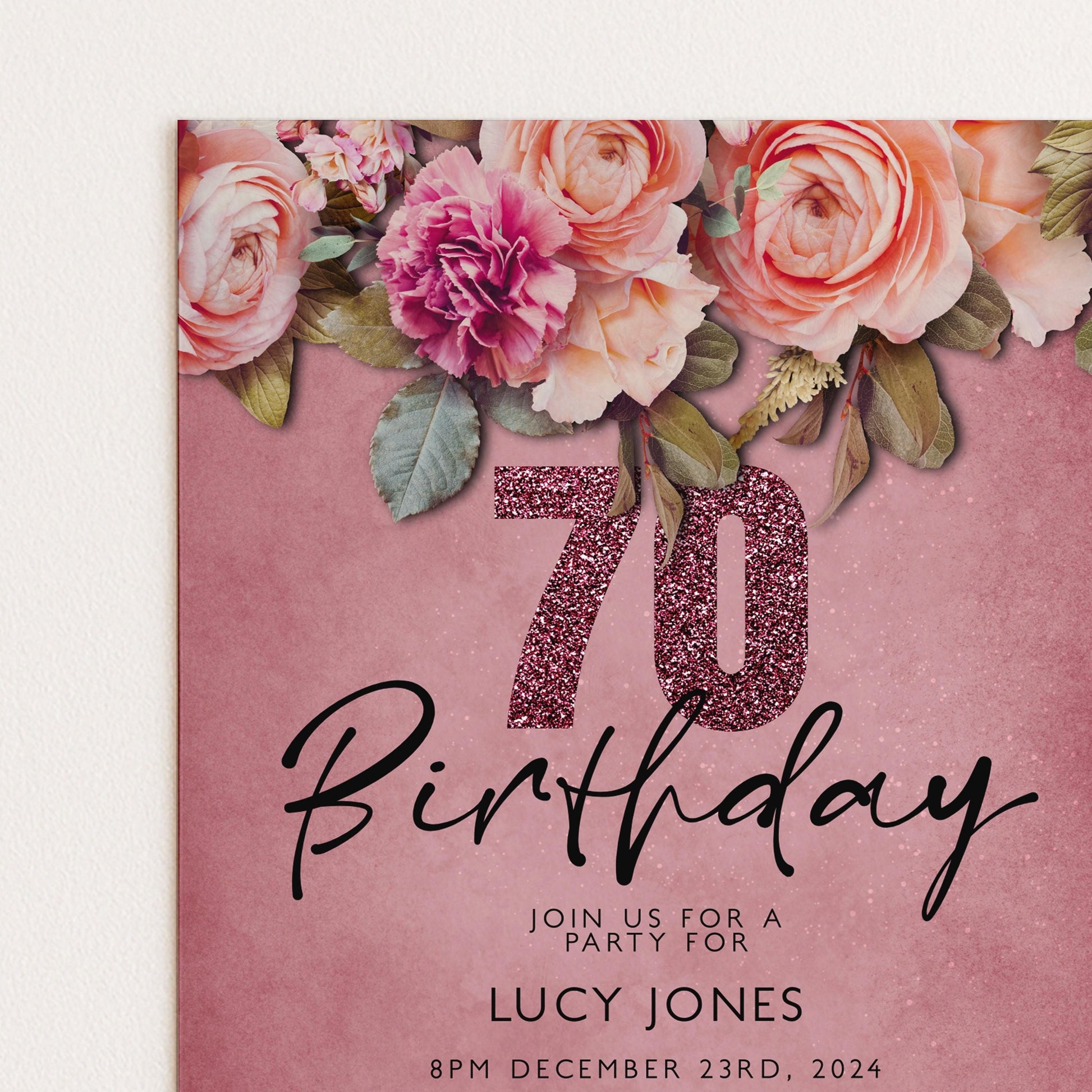 A pink birthday party invitation with a floral design and the number 70.