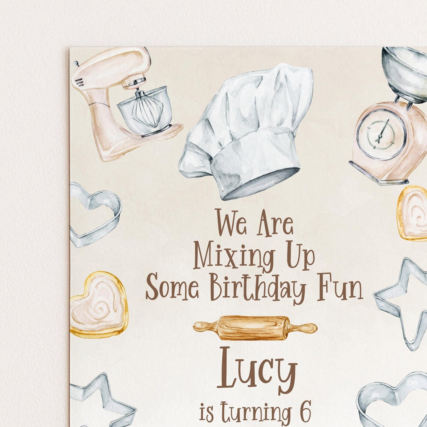 The image is a birthday card for a child named Lucy, who is turning 6 years old. The card features illustrations of baking tools and heart-shaped cookies, along with the text "We Are Mixing Up Some Birthday Fun" and "Lucy is turning 6".