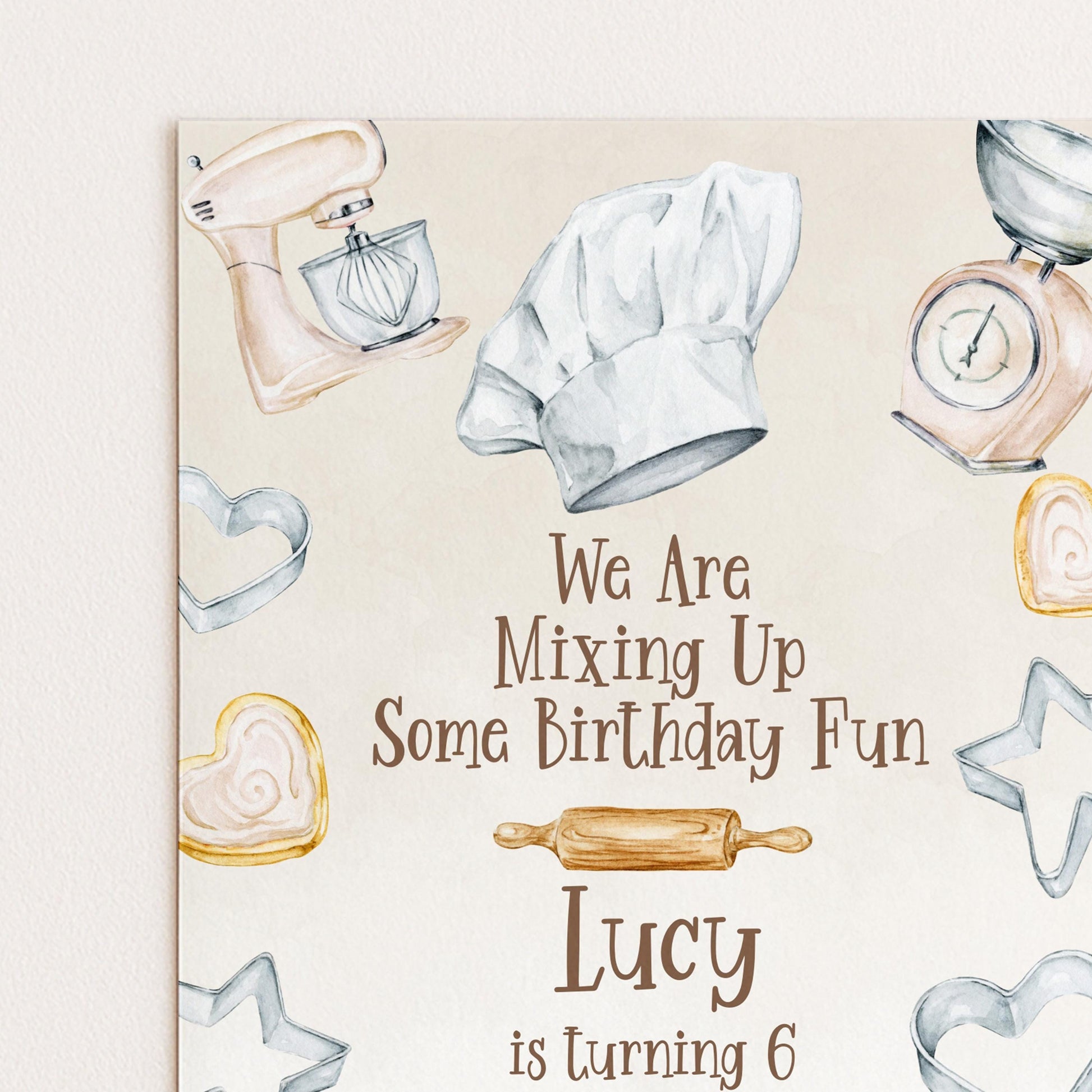 The image is a birthday card for a child named Lucy, who is turning 6 years old. The card features illustrations of baking tools and heart-shaped cookies, along with the text "We Are Mixing Up Some Birthday Fun" and "Lucy is turning 6".