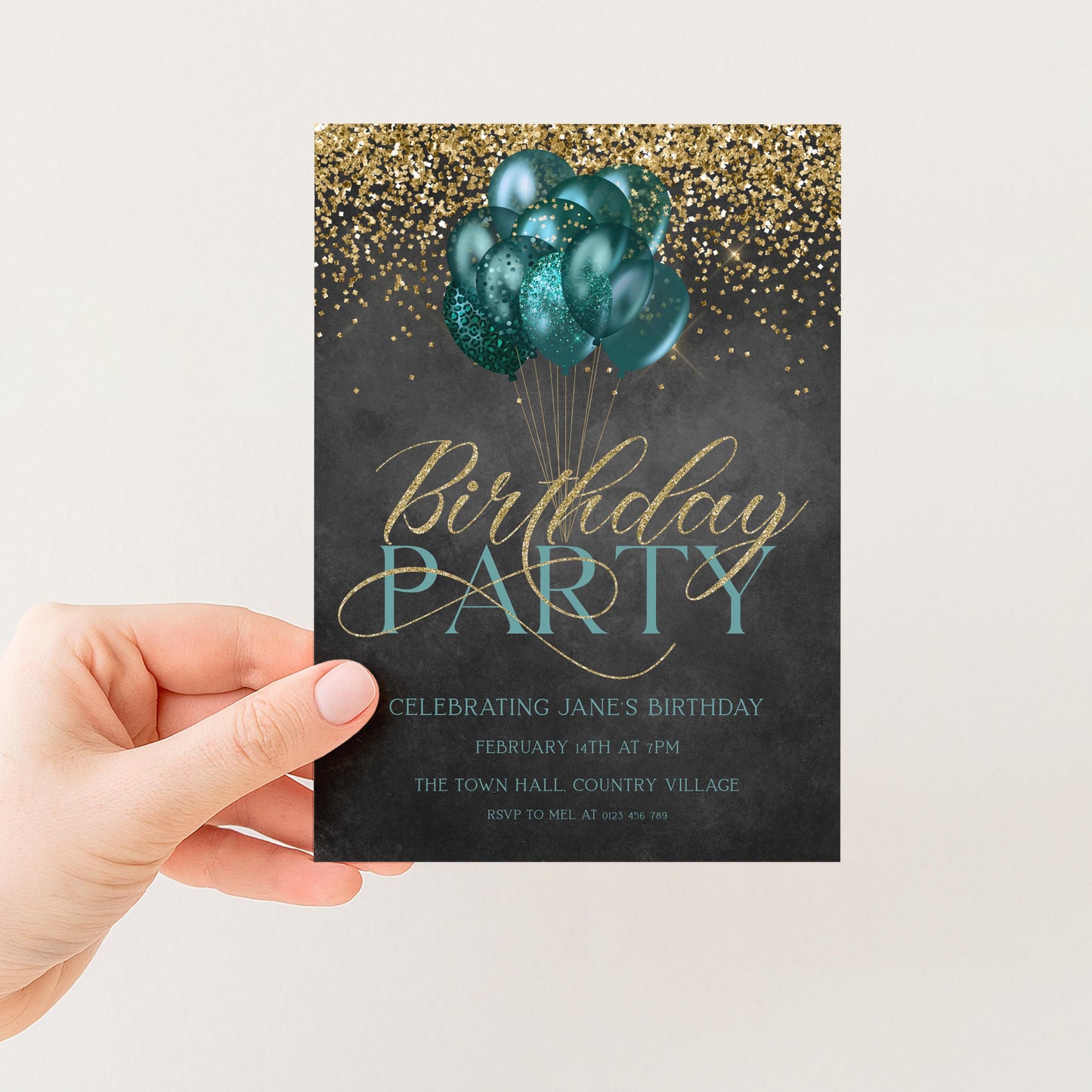 A hand holding a birthday party invitation card with a black background, gold glitter, and a group of green balloons.