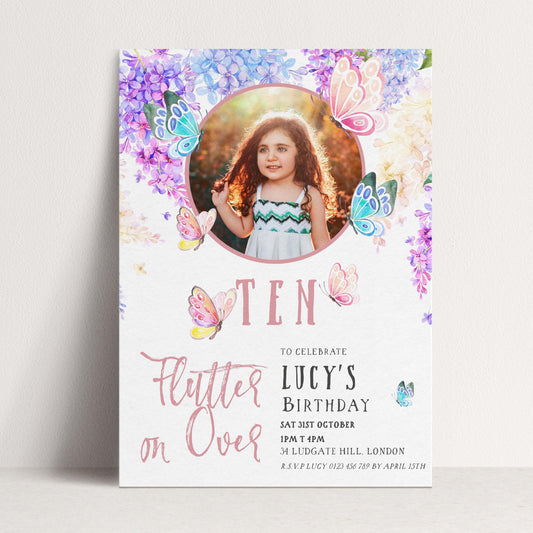 A birthday invitation for a young girl named Lucy, featuring a photo of her surrounded by colorful butterflies and flowers.