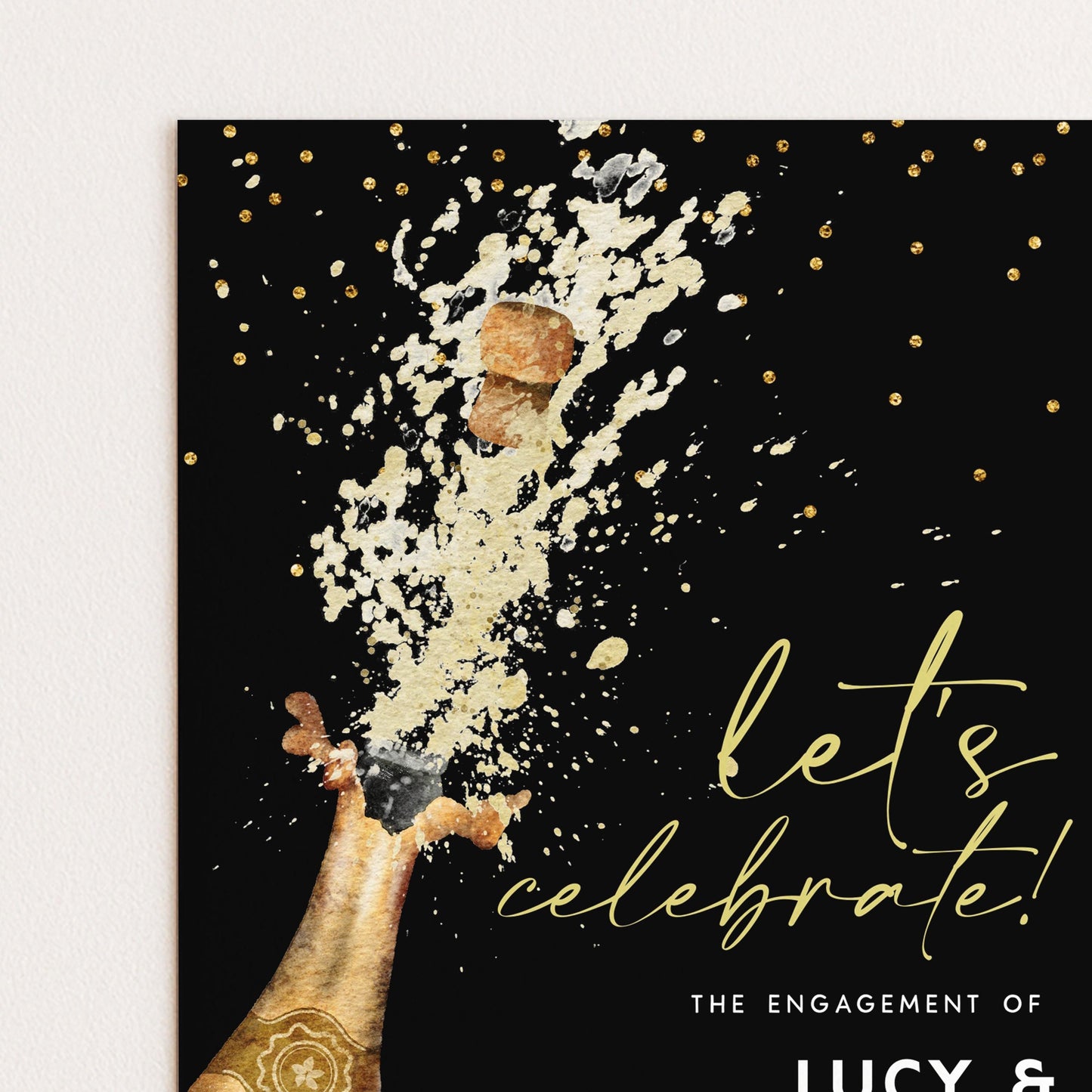 a champagne bottle popping, with a splash of champagne and sparkles, accompanied by the text "let's celebrate! The engagement of LUCY &"