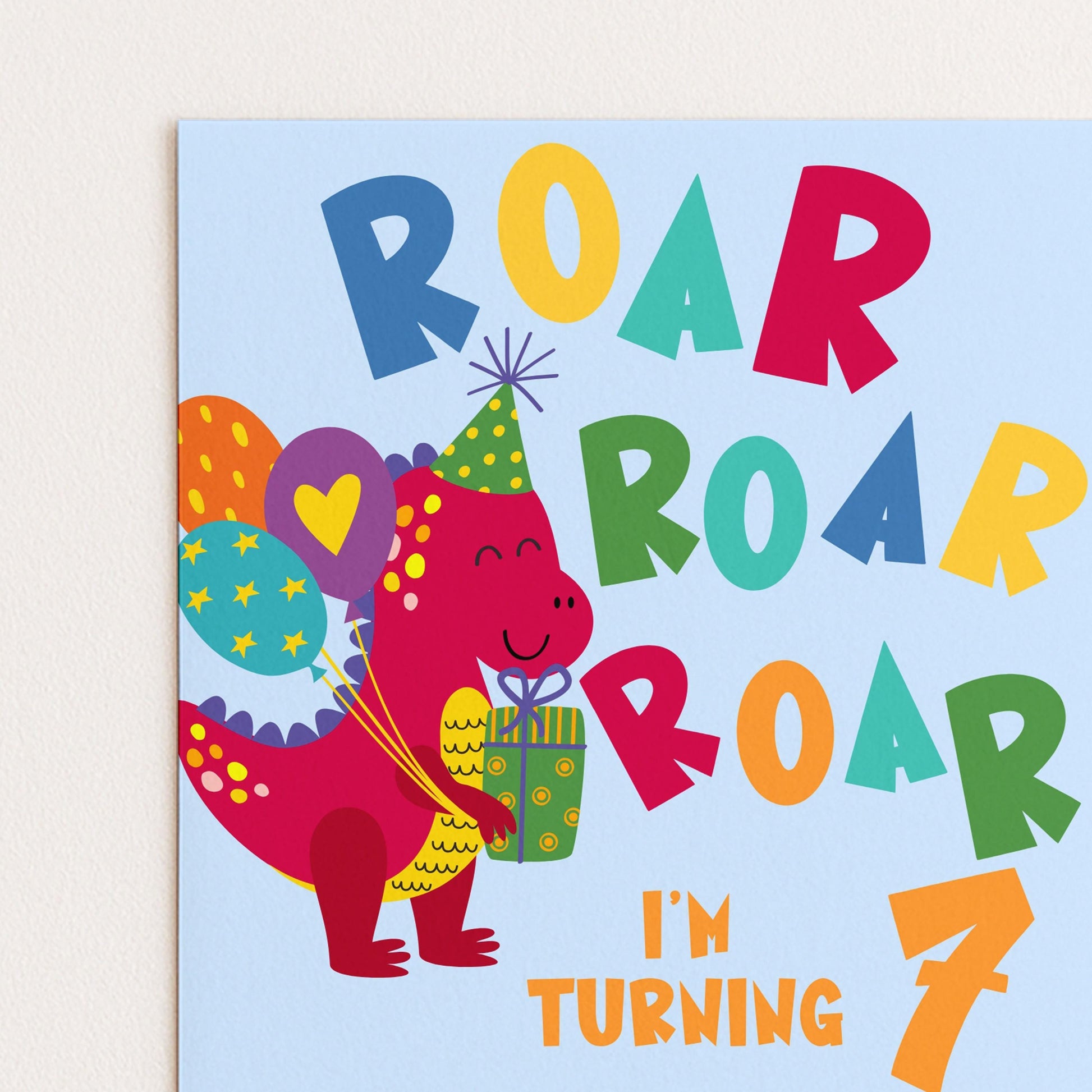 The image is a birthday card for a 7-year-old, featuring a cartoon dinosaur character holding a gift and balloons.