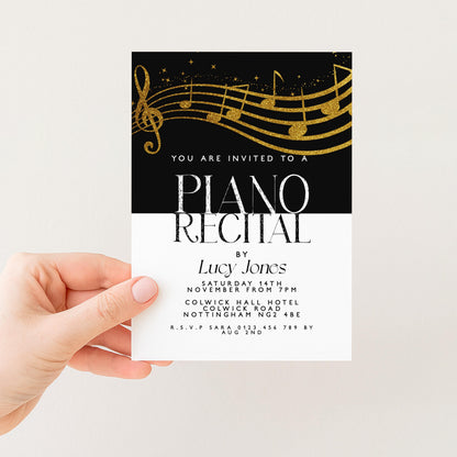 The image is a hand holding a printed invitation card for a piano recital.