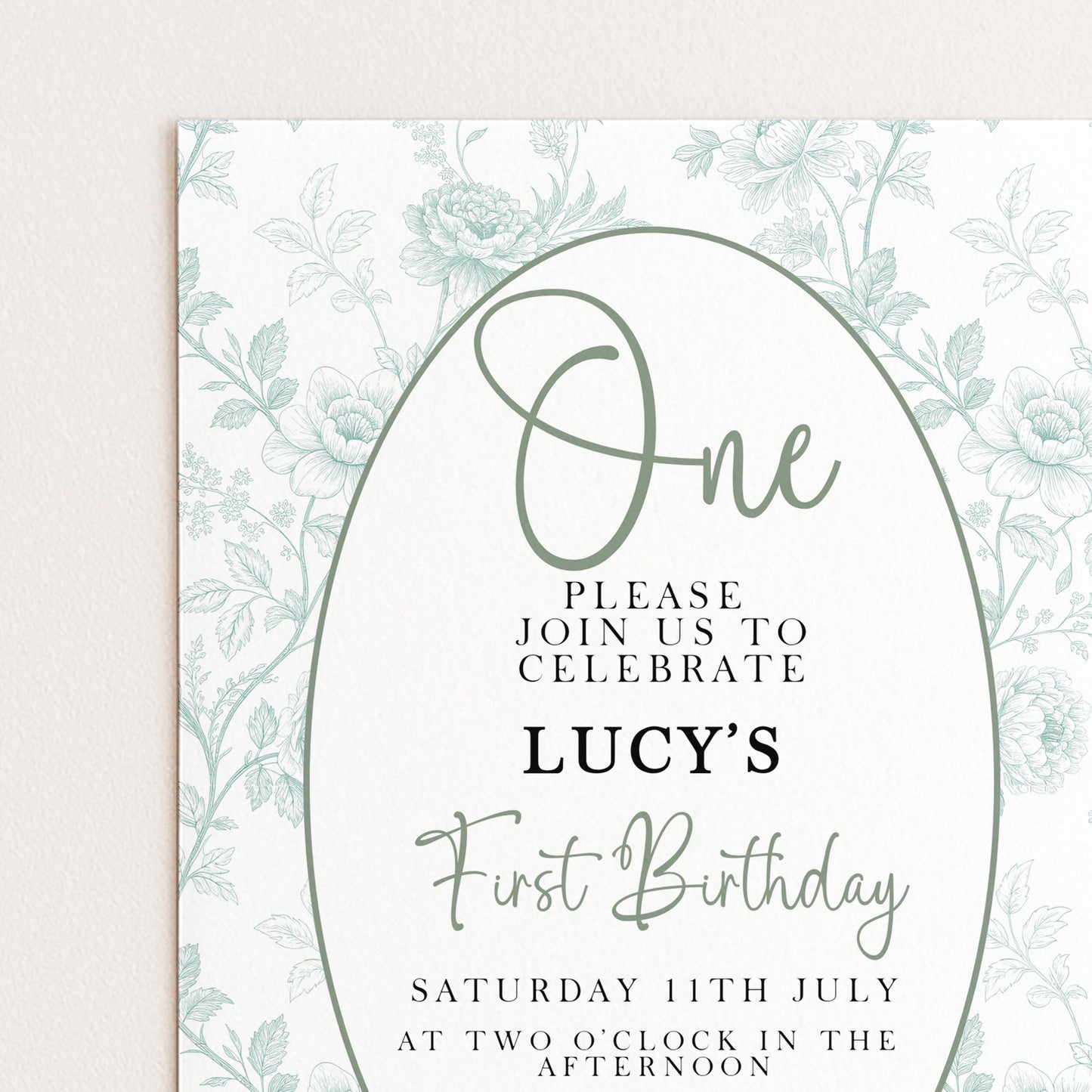 The image is a birthday invitation for a girl named Lucy's first birthday. It features a floral design and includes text inviting guests to join the celebration.