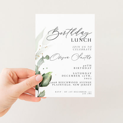 A hand holding a white invitation card with a green leaf design and text.