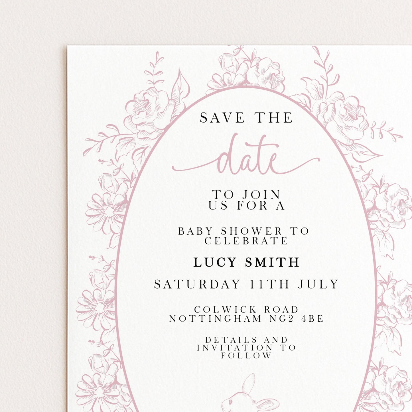 The image is a pink and white invitation card for a baby shower, featuring a floral border and text inviting guests to join for a baby shower to celebrate Lucy Smith's birthday.
