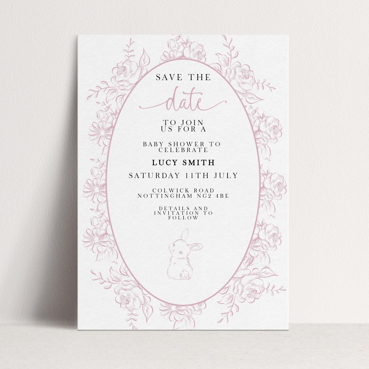 The image is a pink and white invitation card for a baby shower, featuring a floral border and text inviting guests to join for a baby shower to celebrate Lucy Smith.