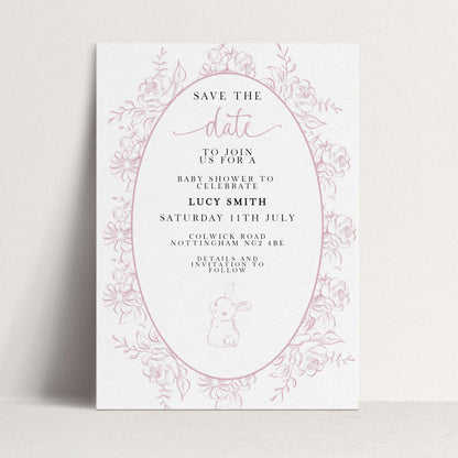 The image is a pink and white invitation card for a baby shower, featuring a floral border and text inviting guests to join for a baby shower to celebrate Lucy Smith.