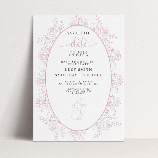 The image is a pink and white invitation card for a baby shower, featuring a floral border and text inviting guests to join for a baby shower to celebrate Lucy Smith.