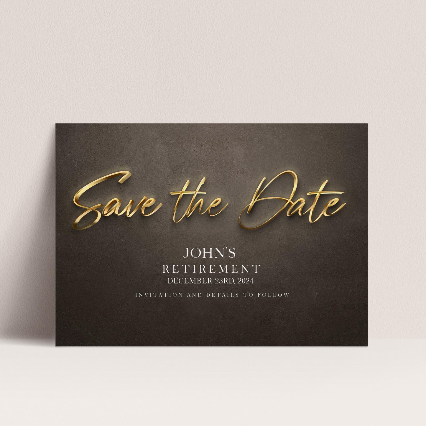 The image is a black and white photograph of a wedding invitation card with gold text and details about John's retirement.