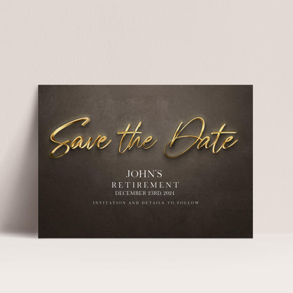 The image is a black and white photograph of a wedding invitation card with gold text and details about John's retirement.