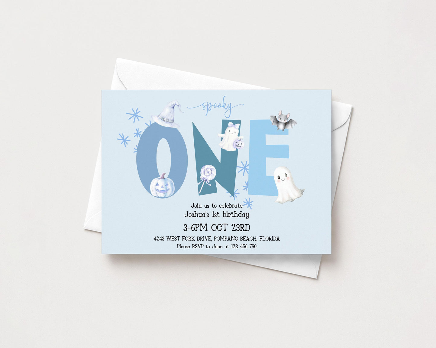 The image is a birthday invitation for a one-year-old, celebrating Joshua's first birthday. The invitation is set against a light blue background and features various Halloween-themed illustrations, including a bat, ghost, and pumpkin.