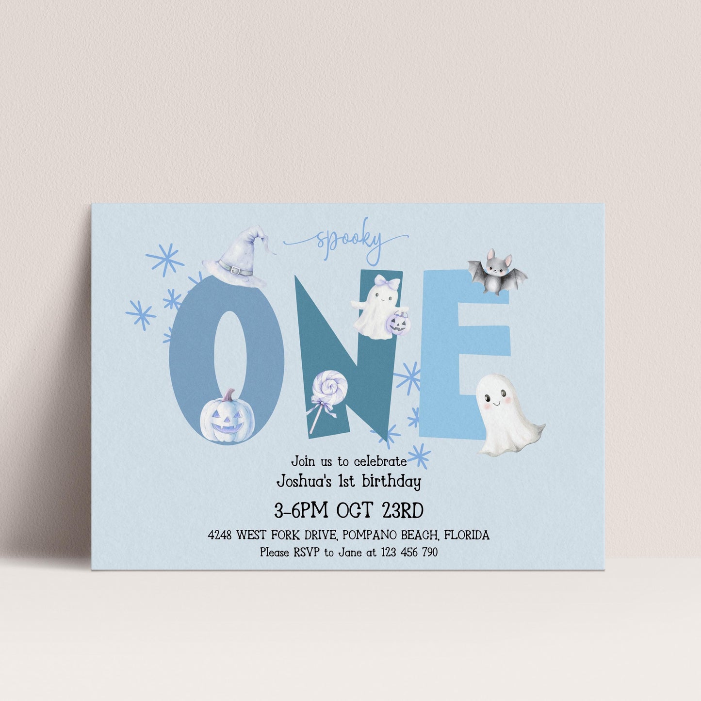 The image is a birthday invitation for a one-year-old named Joshua, celebrating his first birthday. The invitation features a Halloween theme with various spooky and ghostly elements, including a bat, ghost, and pumpkin. The event is scheduled to take place on October 23rd at 4:48 PM at the West Fork Drive, Pompano Beach, Florida. Guests are encouraged to RSVP to June at 125 446-790.