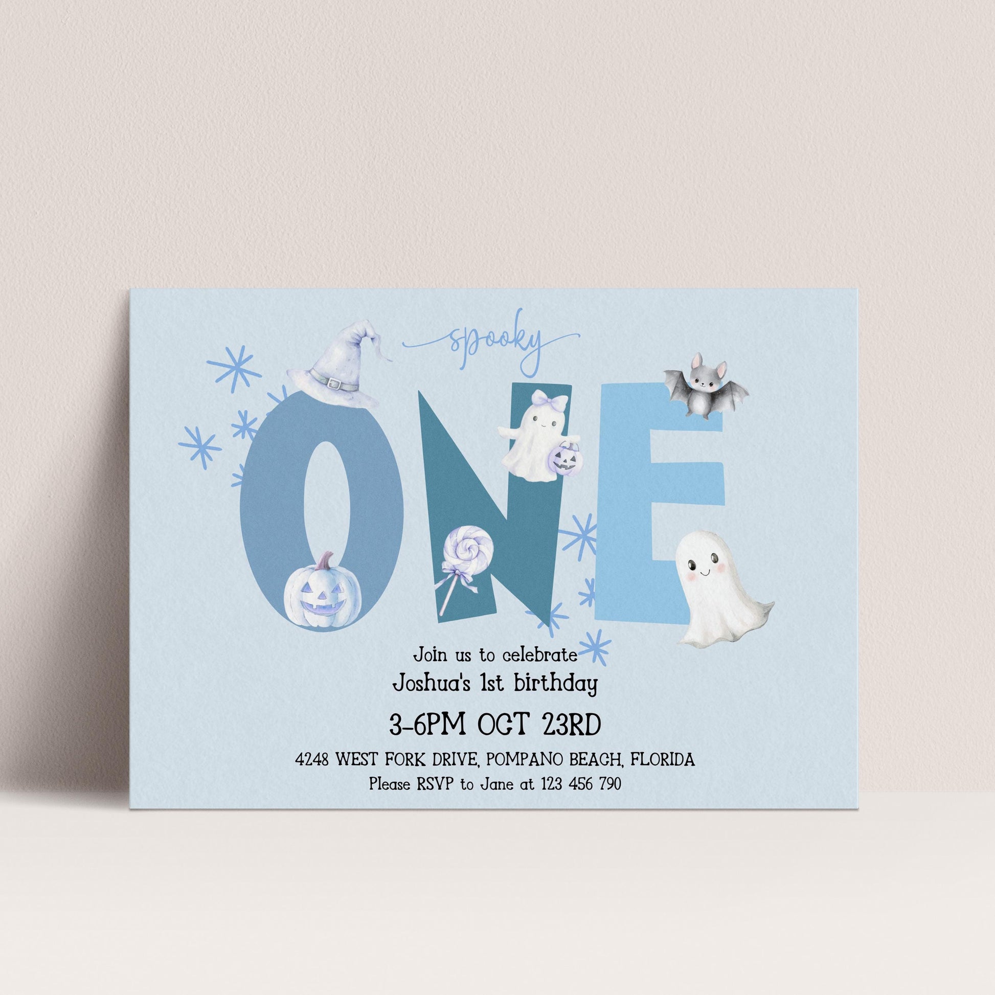 The image is a birthday invitation for a one-year-old named Joshua, celebrating his first birthday. The invitation features a Halloween theme with various spooky and ghostly elements, including a bat, ghost, and pumpkin. The event is scheduled to take place on October 23rd at 4:48 PM at the West Fork Drive, Pompano Beach, Florida. Guests are encouraged to RSVP to June at 125 446-790.