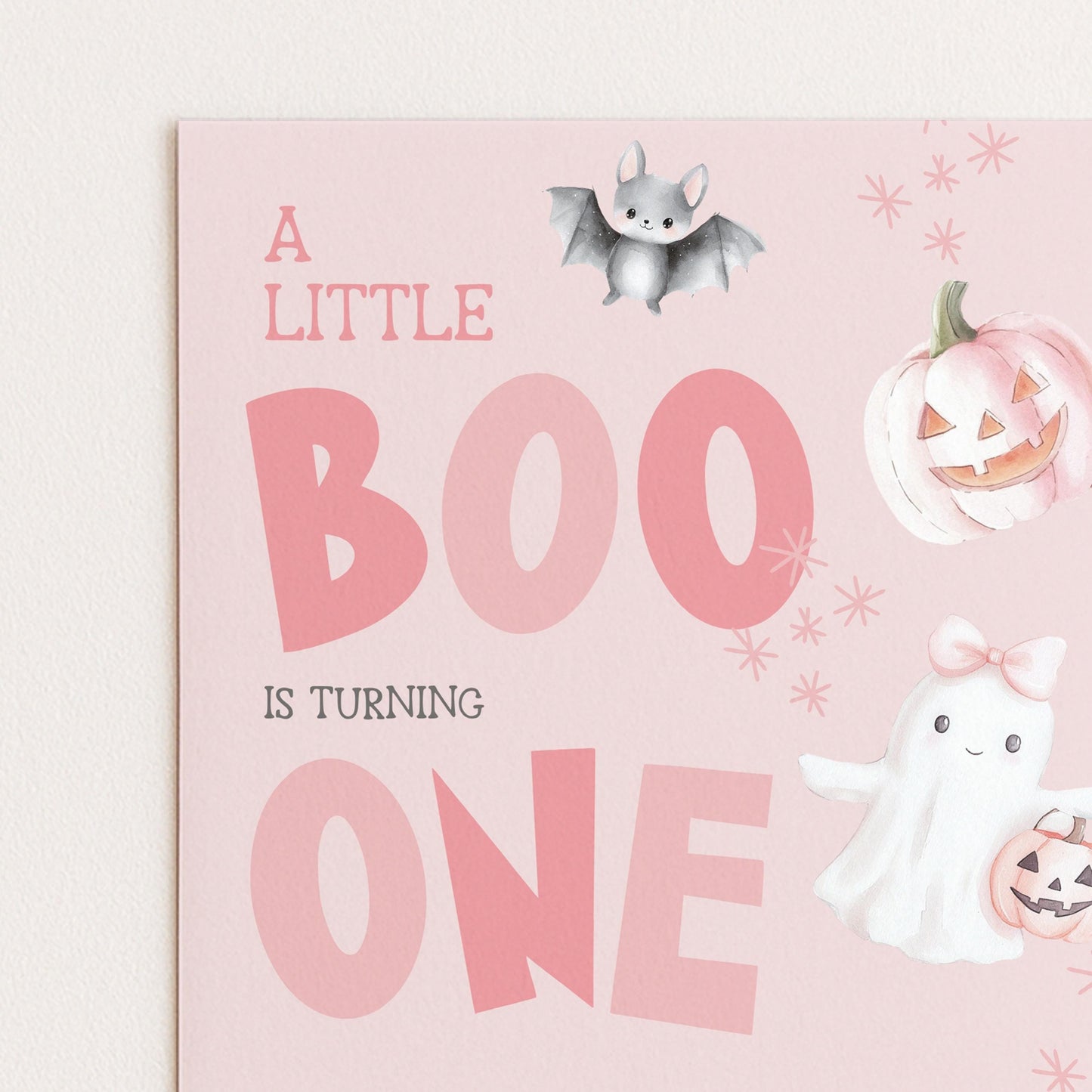 A birthday card with a pink background and illustrations of a bat, pumpkin, and ghost.