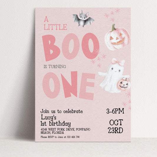 A pink birthday invitation for a little girl's first birthday, featuring a bat, pumpkin, ghost, and a pumpkin with a face.