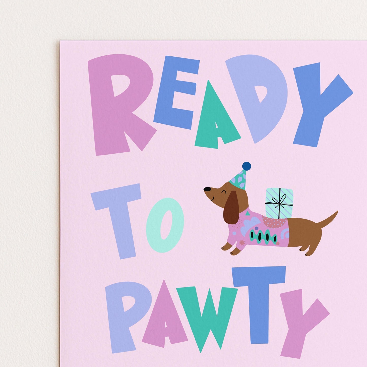 The image is a colorful greeting card with the text "READY TO PAWTY" and an illustration of a dog wearing a party hat and carrying a gift.