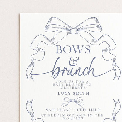 The image is a printed invitation card for a baby shower, featuring a decorative bow and elegant text.