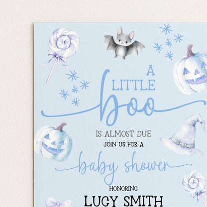 A baby shower invitation with a Halloween theme, featuring illustrations of a bat, a pumpkin, a witch's hat, and a lollipop.