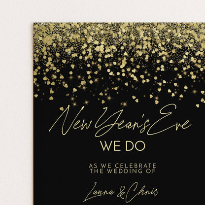 The image is a wedding invitation card with a black background and gold glitter. The text on the card reads "New Year's Eve We Do" and "As we celebrate the wedding of Laura & Chris".