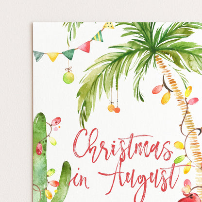 A watercolor painting of a palm tree with colorful ornaments and a banner, along with the text "Christmas in August" written in a decorative font.