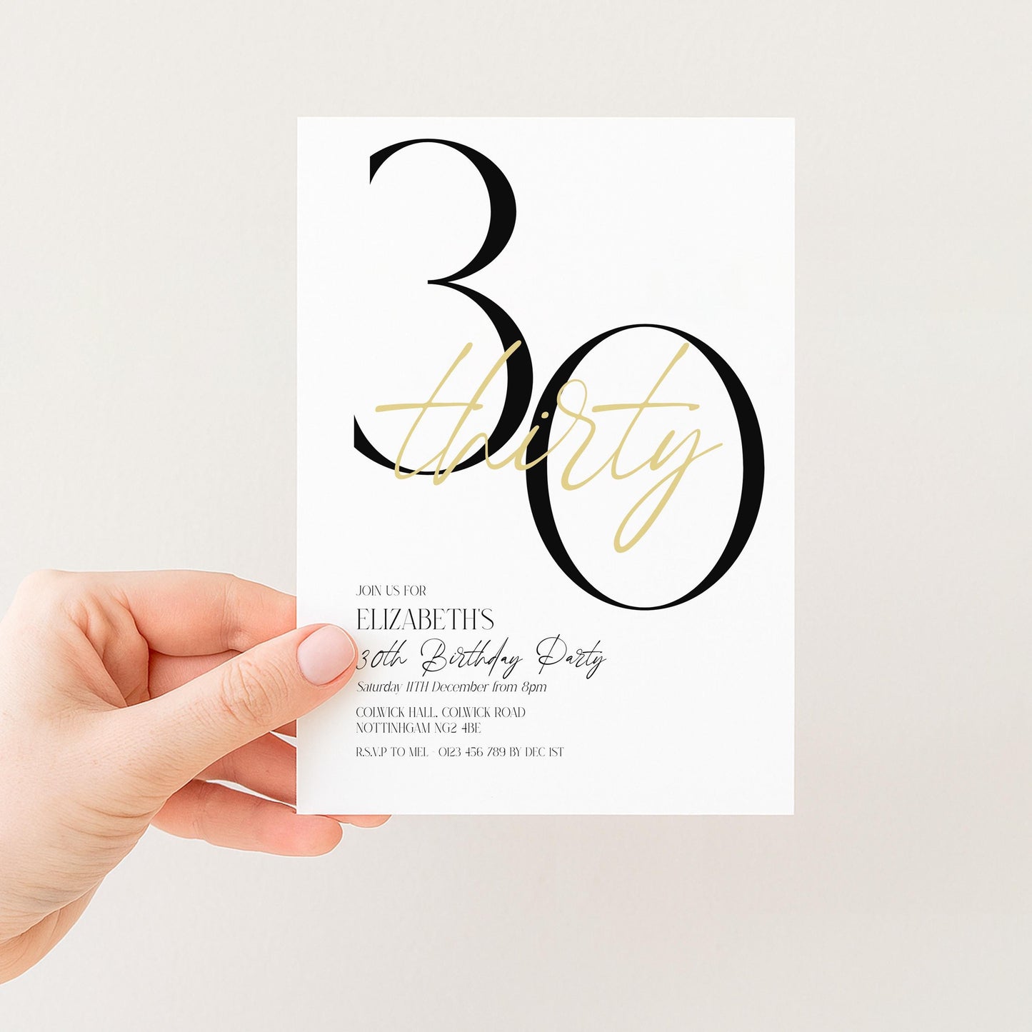 A person's hand holding a white invitation card with black text and design.