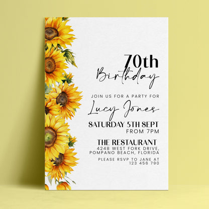 The image is a birthday invitation for a 70th celebration for Lucy Jones. The invitation features a yellow sunflower design on the left side and includes details about the party, including the date, time, location, and contact information.