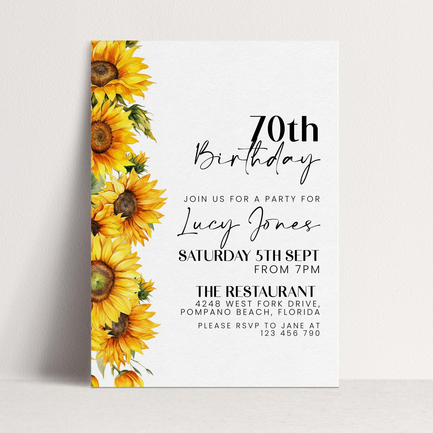 The image is a birthday invitation for a 70th birthday party for Lucy Jones. The invitation features a vibrant yellow sunflower design on the left side and includes details about the party, including the date, time, location, and RSVP instructions.