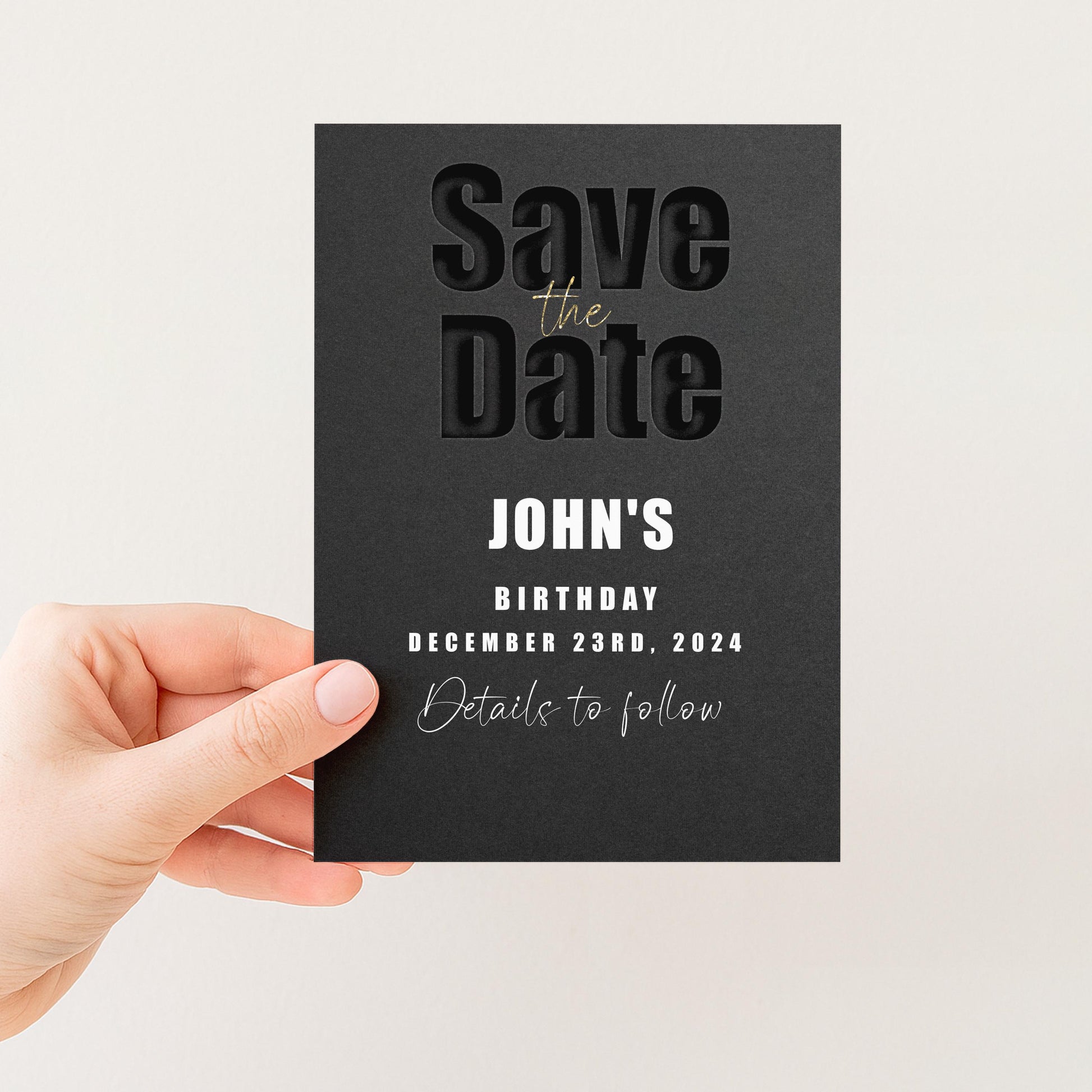 A person's hand holding a black card with text on it.