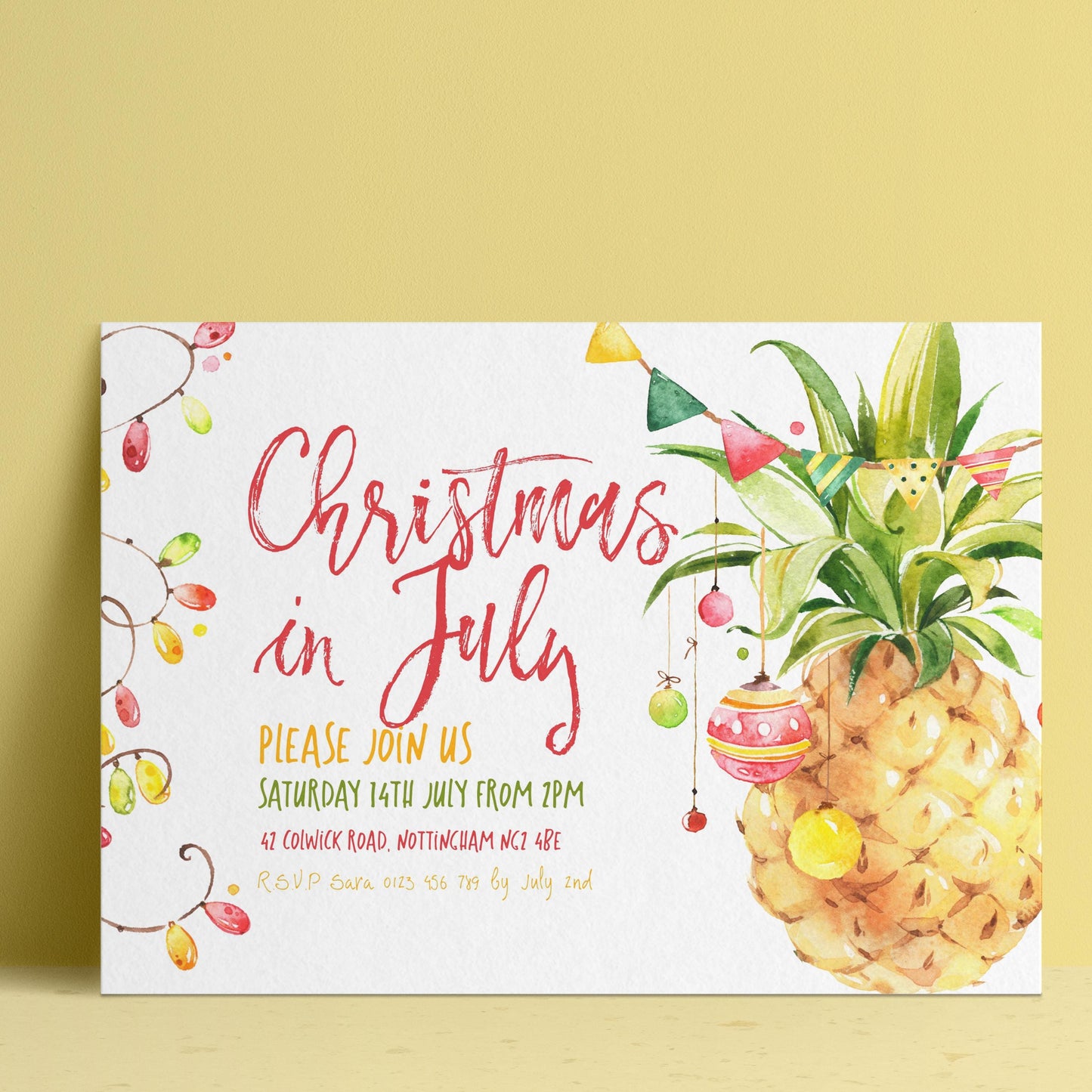 The image is a Christmas in July invitation featuring a pineapple and colorful decorations.