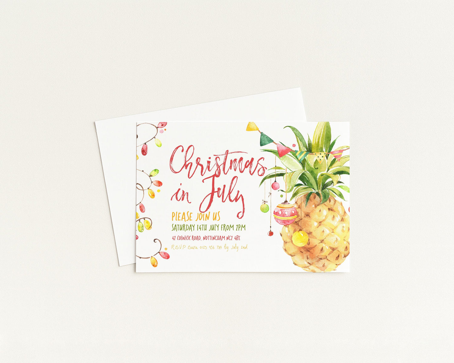 A Christmas in July invitation card featuring a pineapple graphic and colorful text.