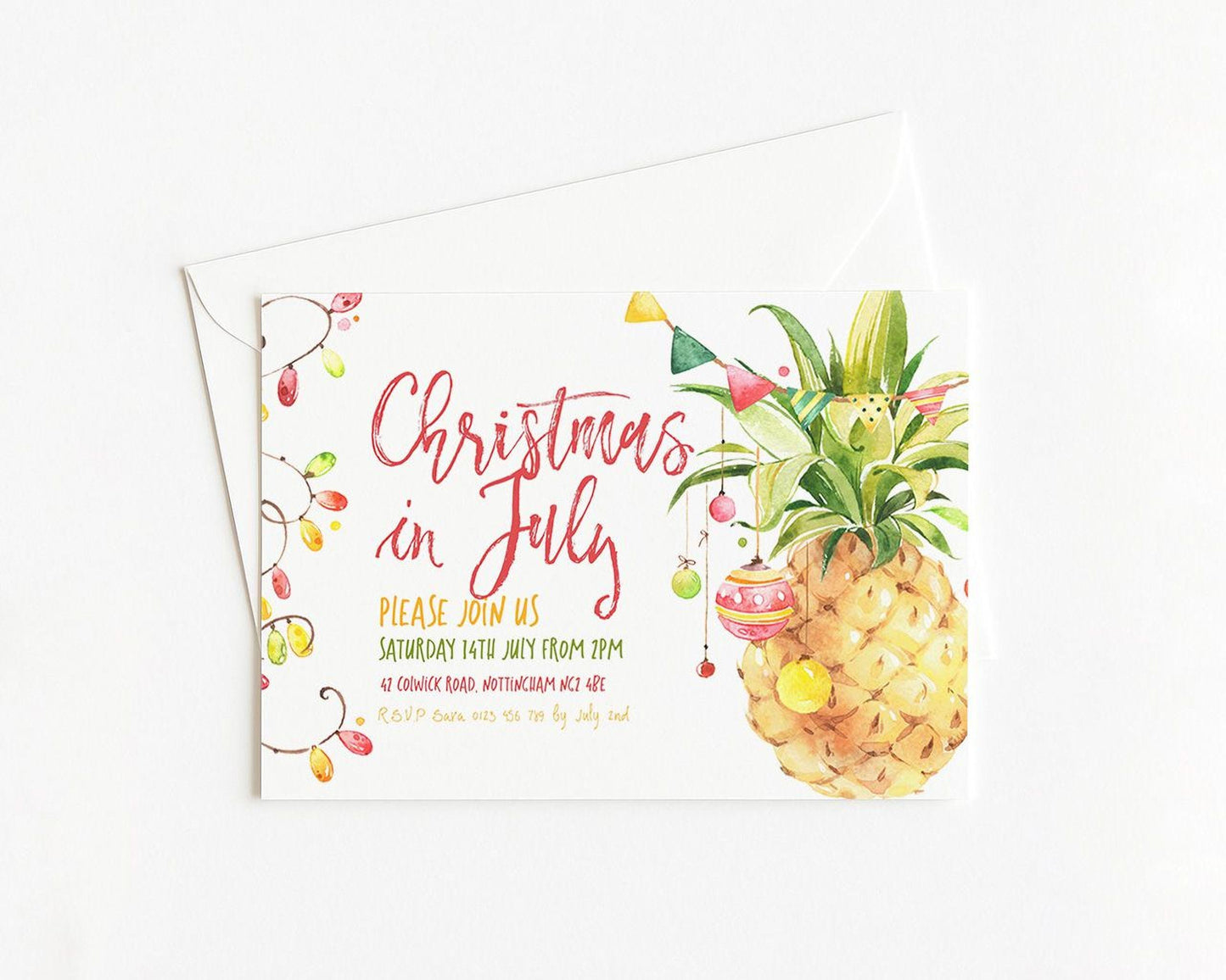 A Christmas in July invitation card featuring a pineapple with colorful ornaments and lights.