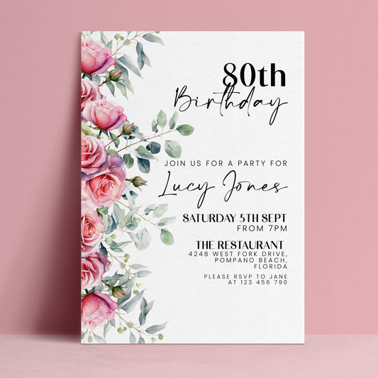 The image is a birthday invitation for a woman named Lucy Jones celebrating her 80th birthday. The invitation is set against a pink background and features a floral design with pink roses and greenery.