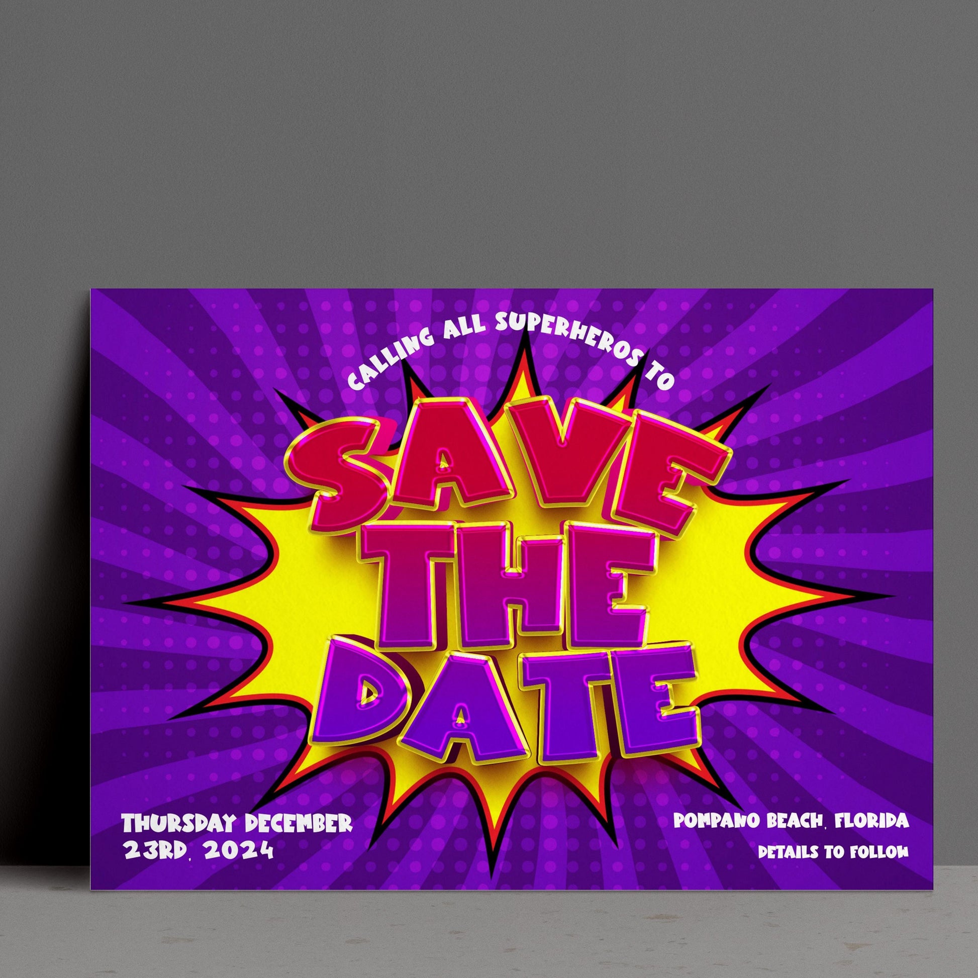 The image is a colorful poster with a large text explosion design that says "SAVE THE DATE" in a vibrant purple and yellow color scheme. The poster is promoting an event called "CALLING ALL SUPERHEROES TO SAVE THE DATE" on Thursday, December 23rd, 2014 at Pompano Beach, Florida.