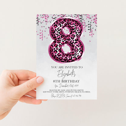 A hand holding a birthday invitation card with a large number 8 and pink and black leopard print design.