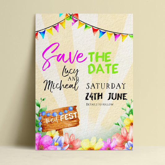 The image is a colorful wedding invitation featuring a wooden sign, flowers, and a string of multicolored flags.