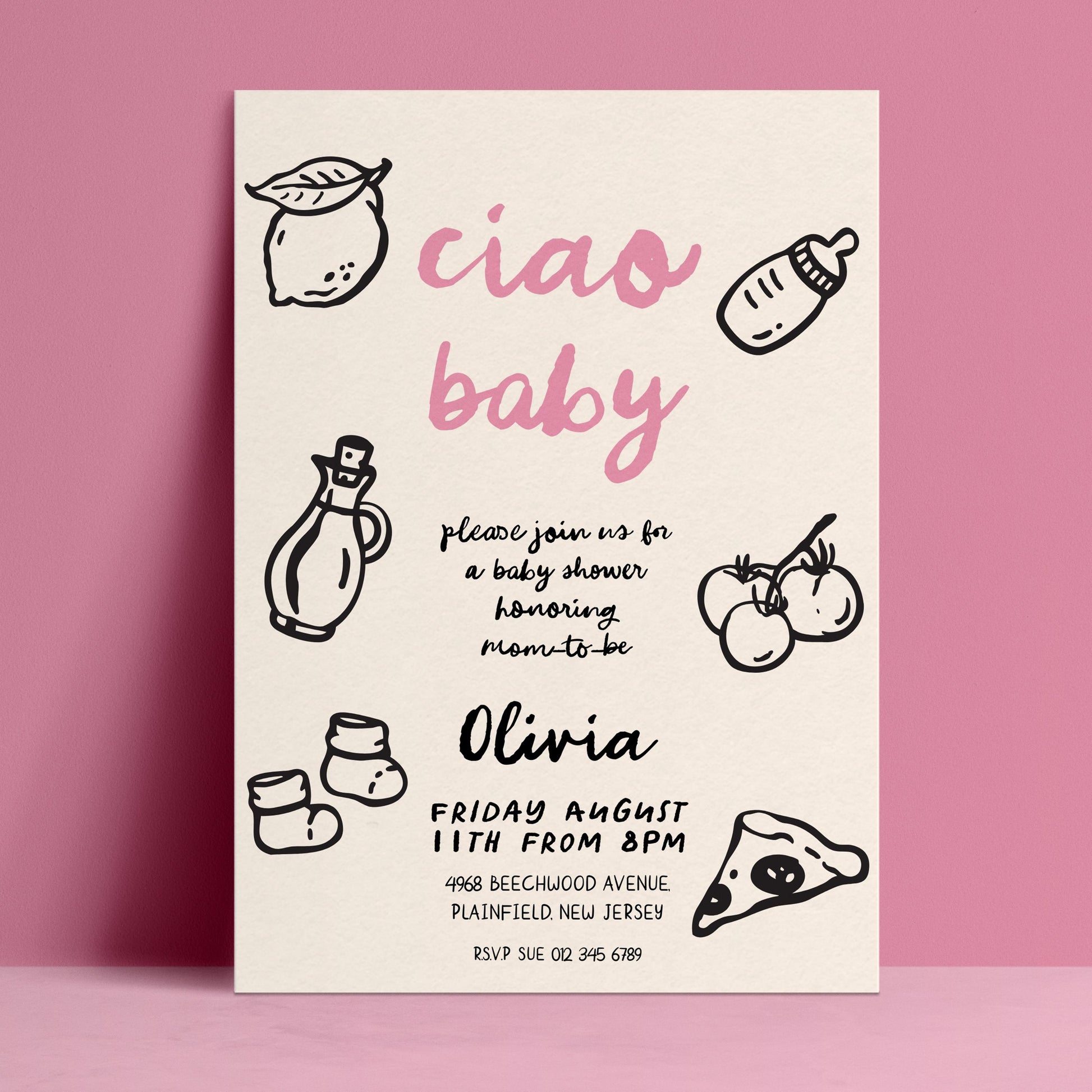 The image is a baby shower invitation featuring a pink background with black text and illustrations of baby-related items such as a bottle, a lemon, and baby socks.