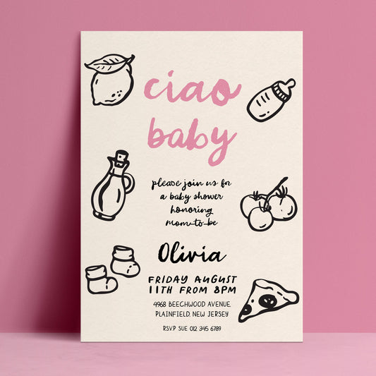 The image is a baby shower invitation featuring a pink background with black text and illustrations of baby-related items such as a bottle, a lemon, and baby socks.