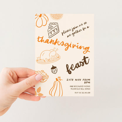The image is a hand holding a Thanksgiving feast invitation card.