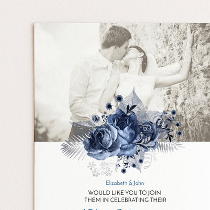 A black and white photograph of a couple embracing, with a floral design in the foreground.