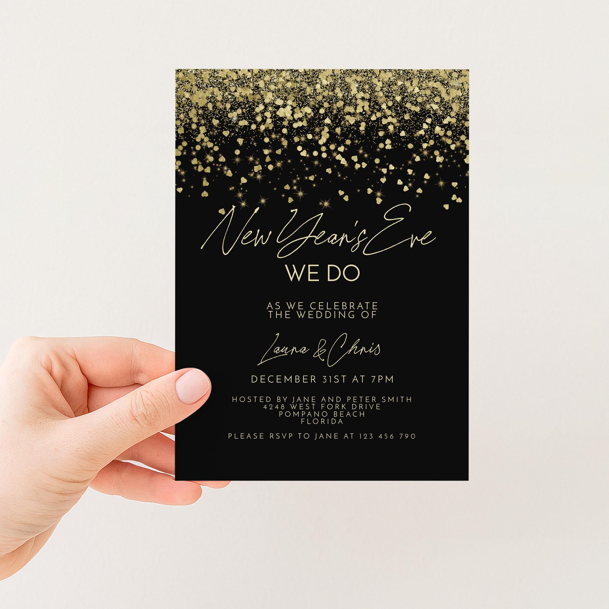 a hand holding a black invitation card with gold glitter and text.