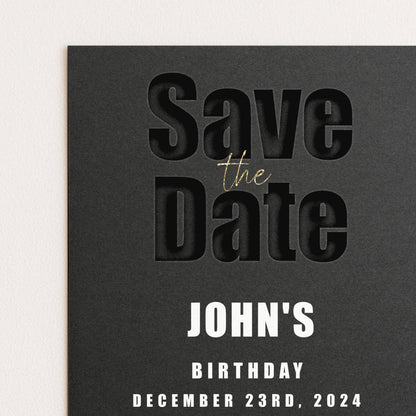 The image is a black and white photograph of a save the date card for John's birthday.