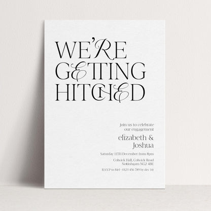 The image is a wedding invitation card with a minimalist design featuring the text "WE'RE GETTING HITCHED" in a large font.