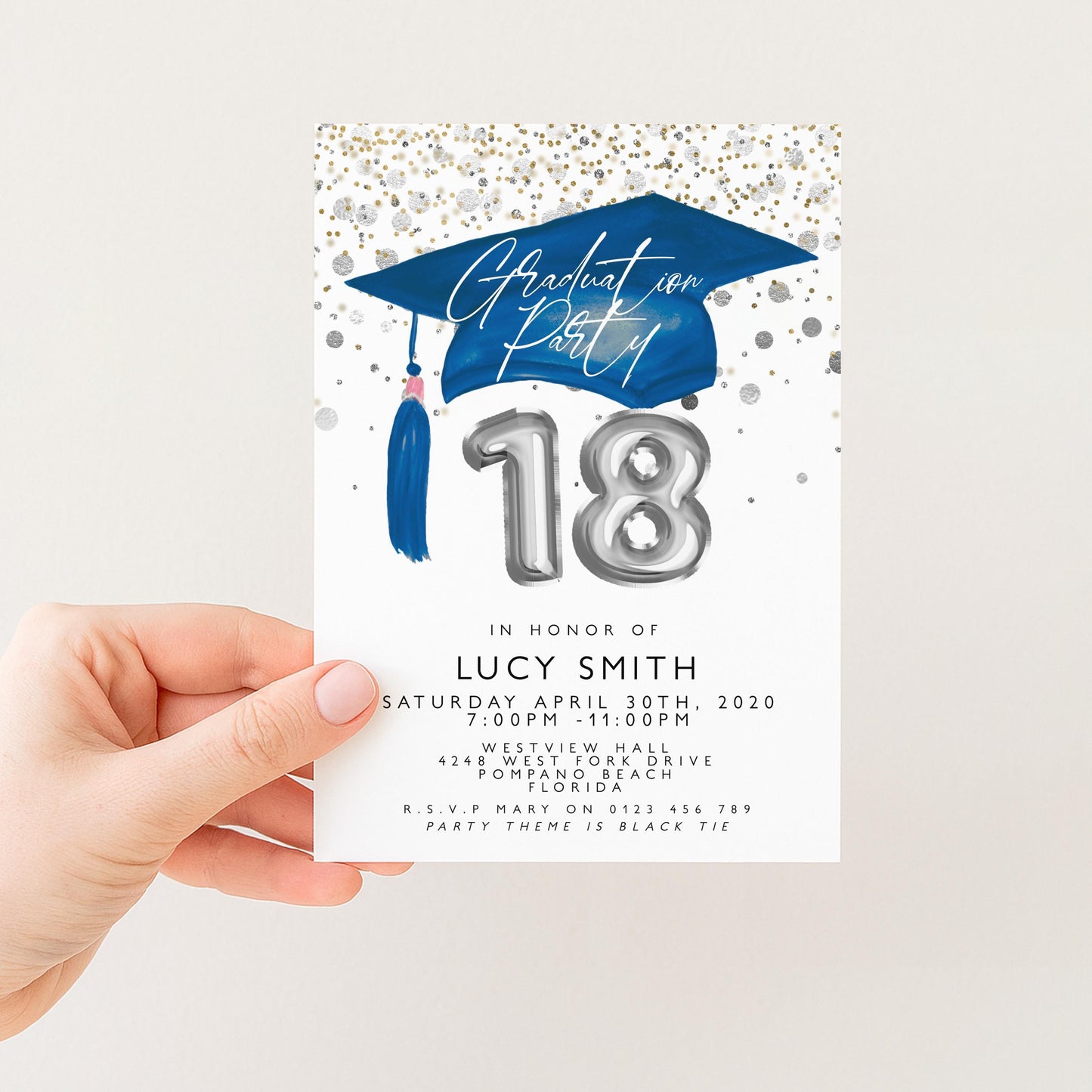 a person holding a graduation party invitation card.