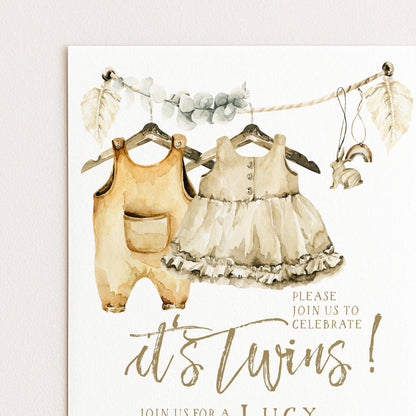 The image is a watercolor painting of two baby outfits hanging on a clothesline, with a sign below inviting people to "Join us for a Lucy's Twins" event.