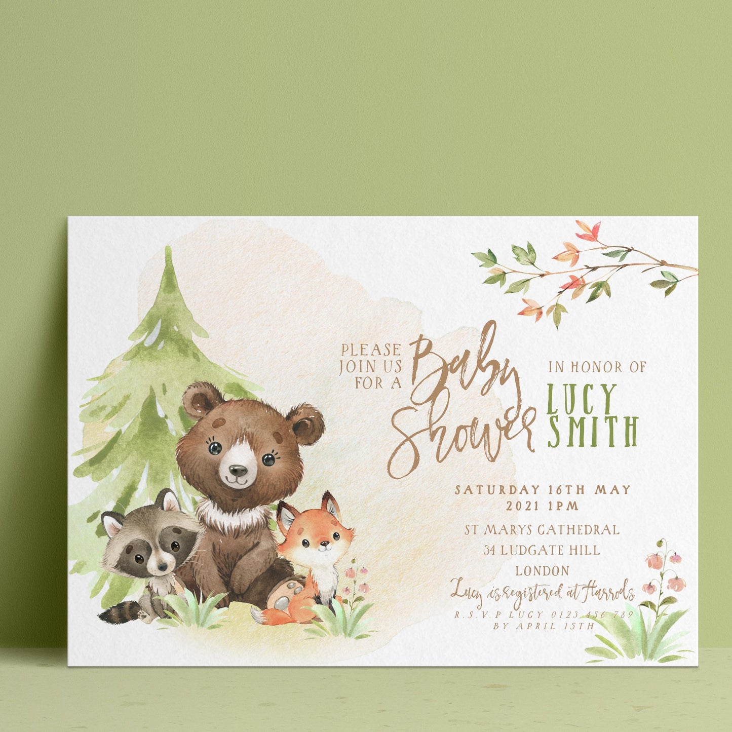 The image is a baby shower invitation featuring a bear, raccoon, and fox surrounded by a forest scene.