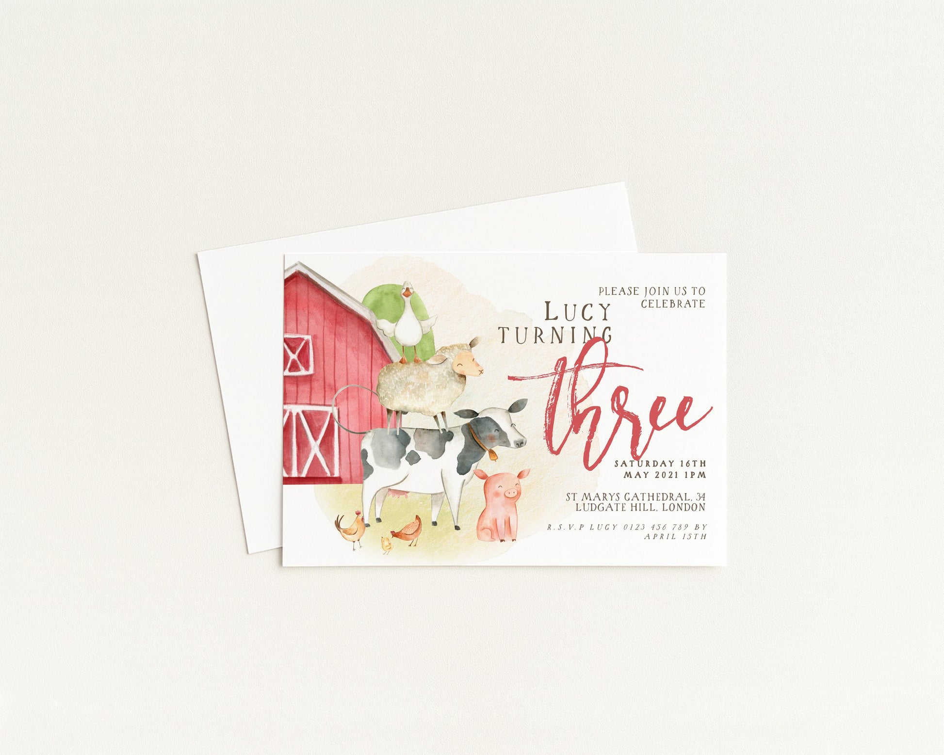 The image is a birthday invitation for a girl named Lucy, who is turning three. The invitation features illustrations of farm animals and a red barn, along with the text "Please join us to celebrate Lucy turning three".